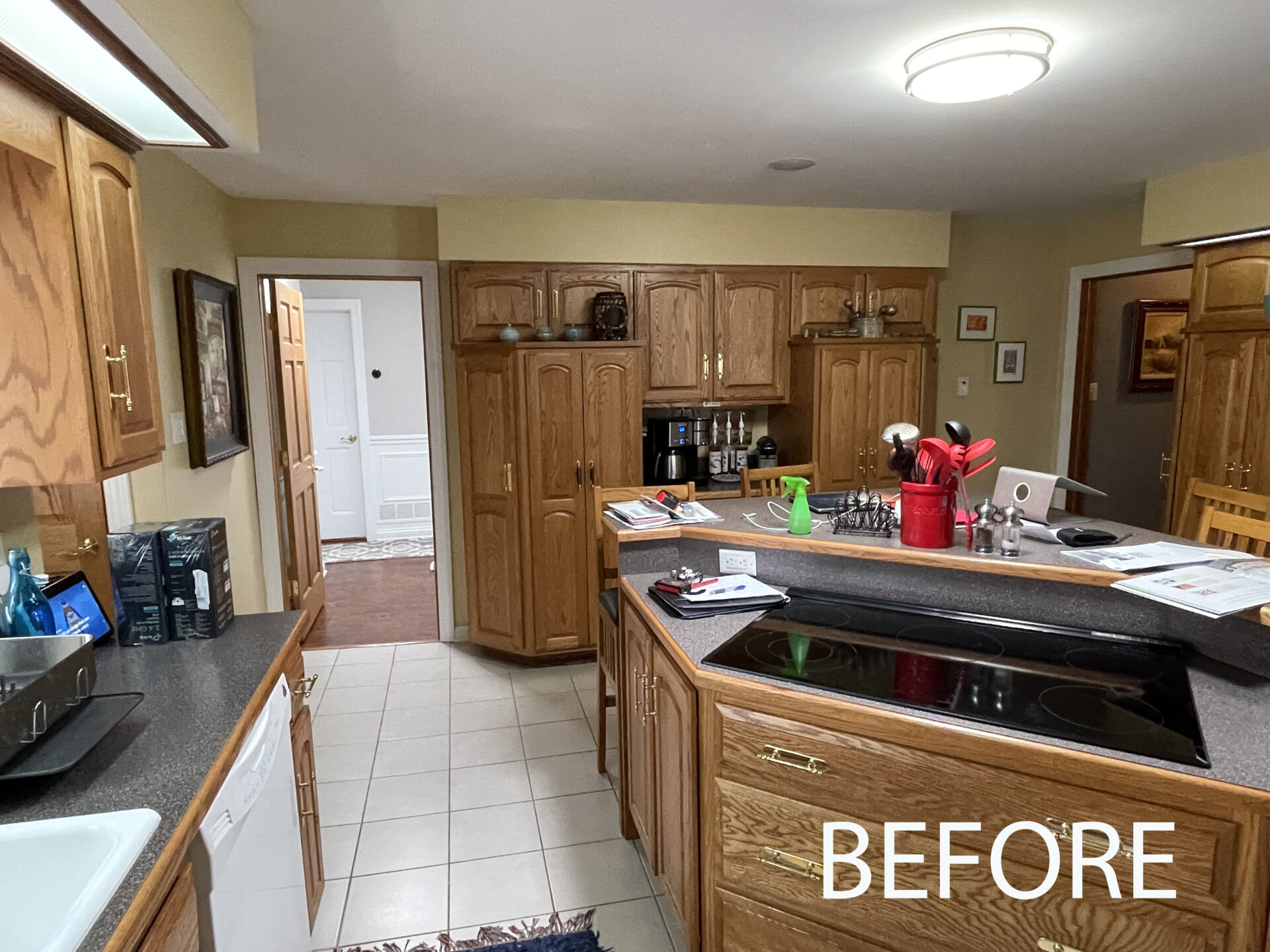 before photo showing cooktop on island, white tile floor