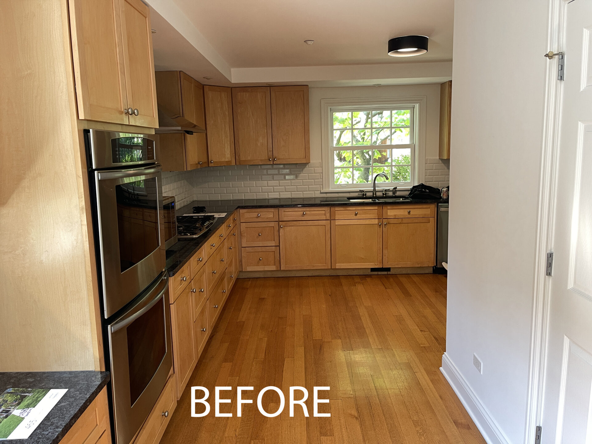 Before kitchen, stained wood cabinets and flooring