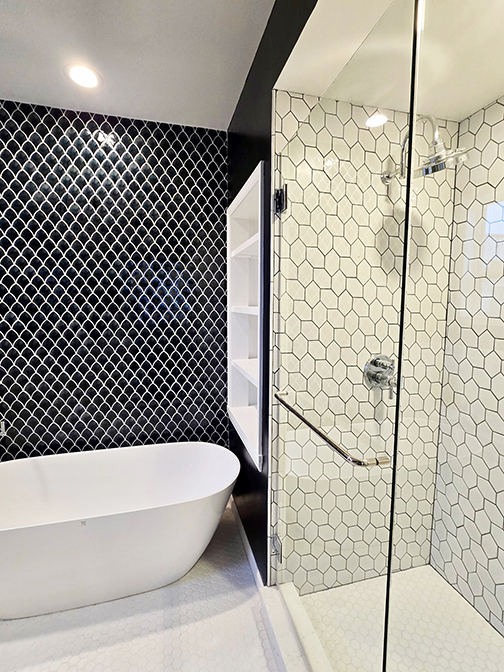 Geometric tile bathroom black tile white tile shower and tub