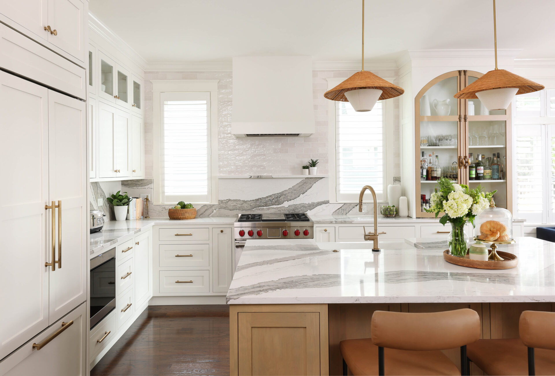 White kitchen with alder wood island, backsplash shelf above range, paneled refrigerator