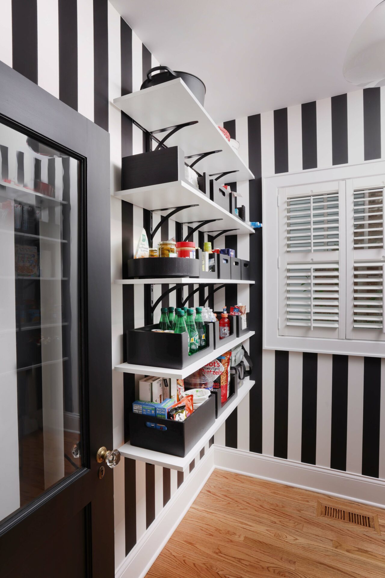 Pantry with shelves accented with black and white striped walls
