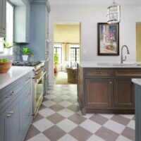 Gray painted cabinets and stained wood cabinets in a vintage inspired kitchen