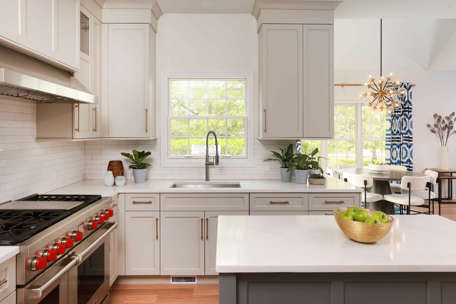 Warm white kitchen with gray island and undermount sink