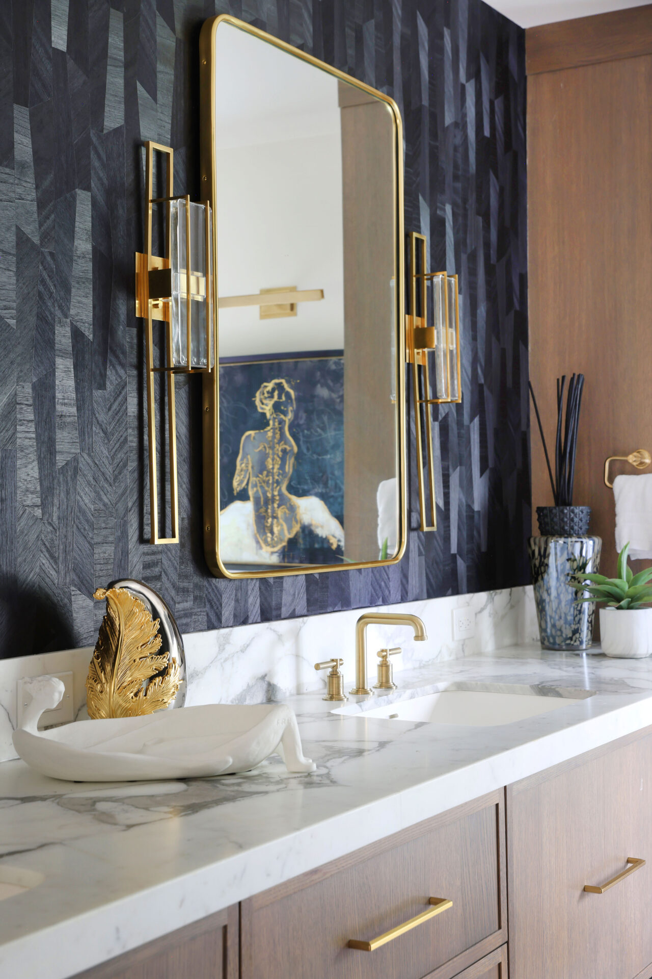 Black textured wallpaper, vanity sconces, marble bathroom countertops