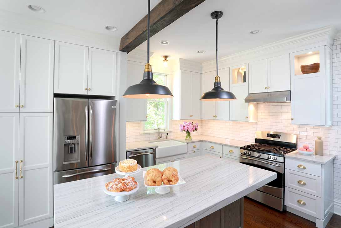 White kitchen cabinets with distressed wood island cabinet and reclaimed wood beams