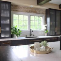 black stained kitchen with glass front cabinets