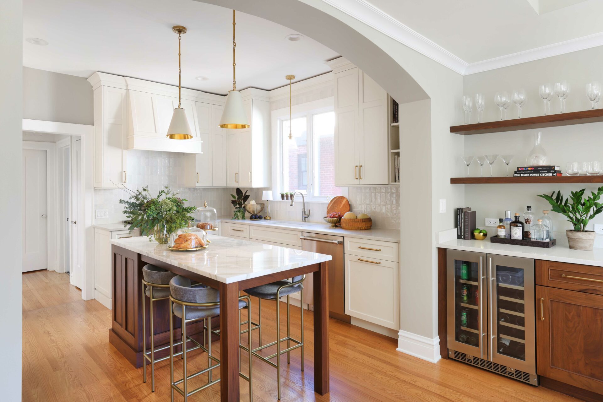 Ivory painted kitchen cabinets with stained walnut island
