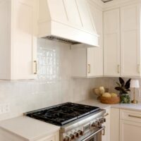 Ivory kitchen with mantle style hood