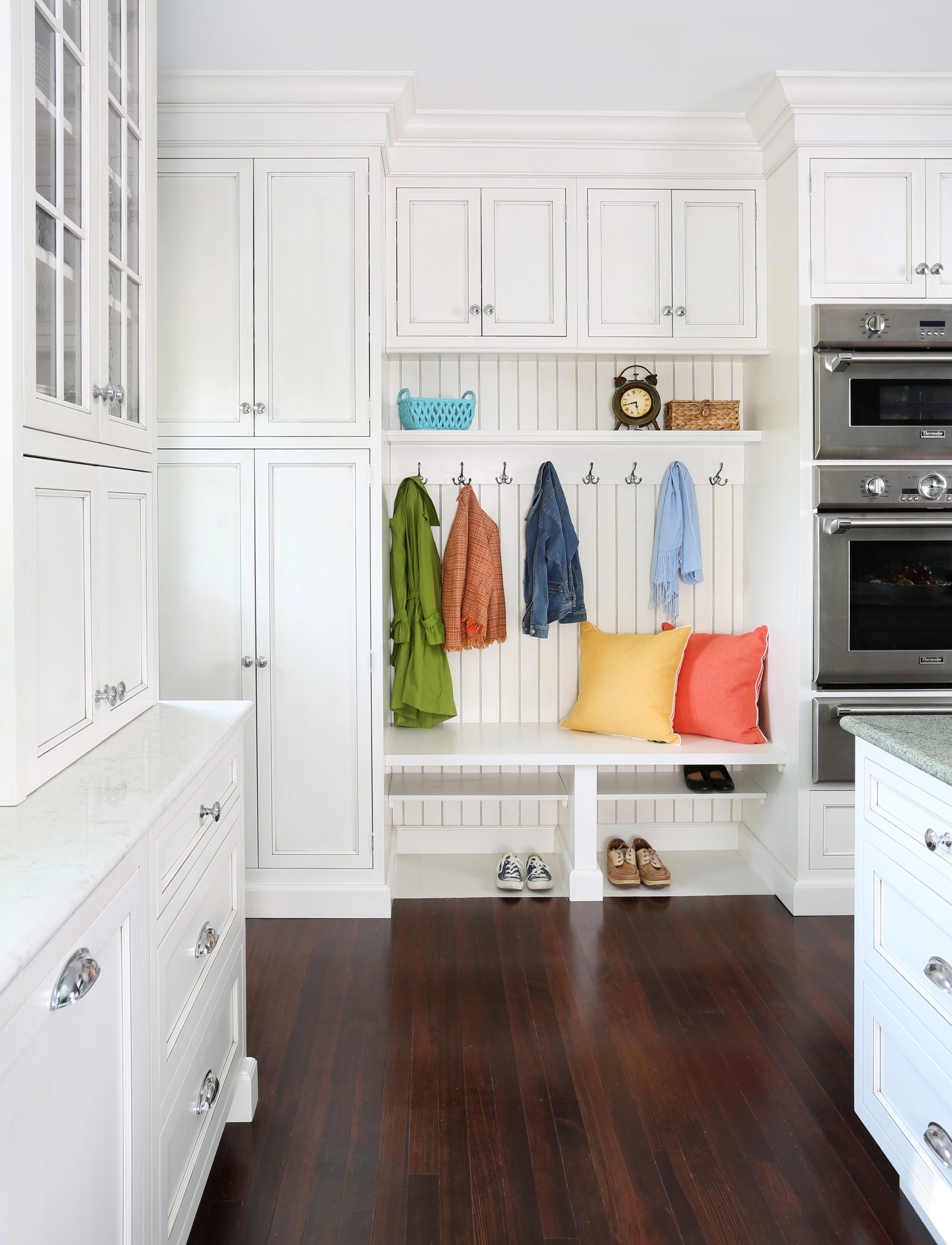 Mudroom space with bead board inside a white kitchen