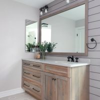 Hickory vanity and shiplap walls in a hall bathroom