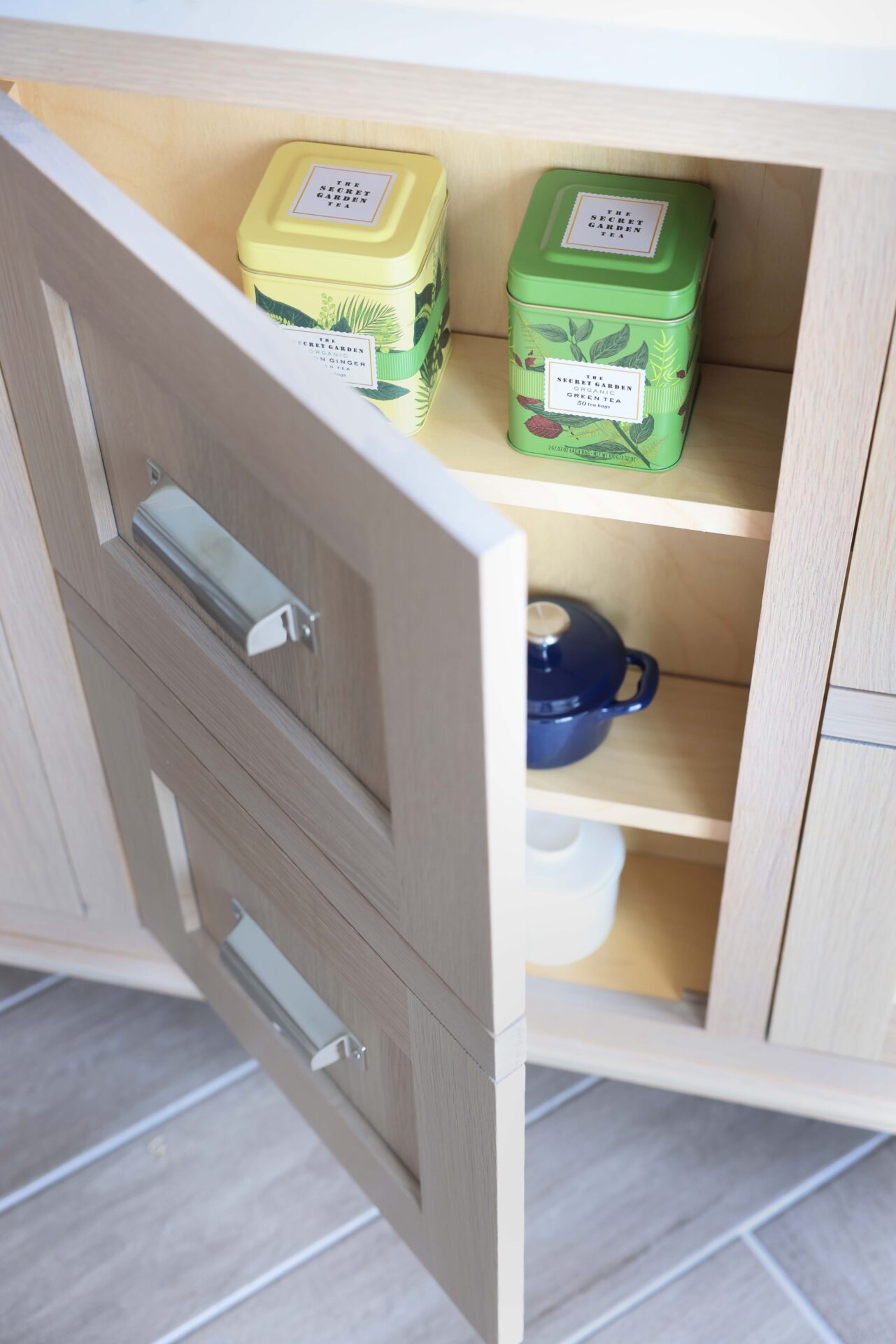 Rift cut white oak kitchen island with drawer facade for cabinet doors, shallow shelving