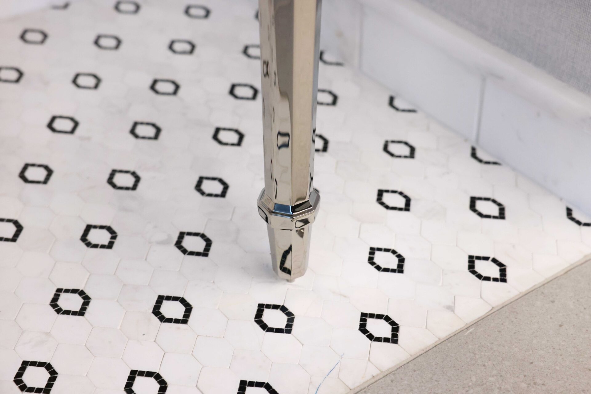 Marble floor mosaic, hexagonal polished nickel vanity leg