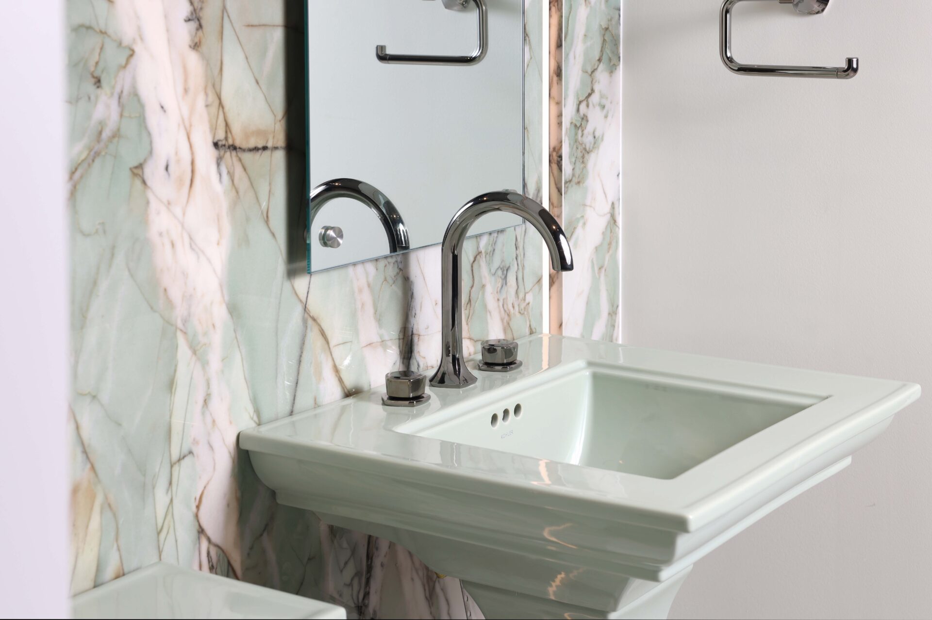 Green porcelain feature wall, floating mirror, titanium faucet