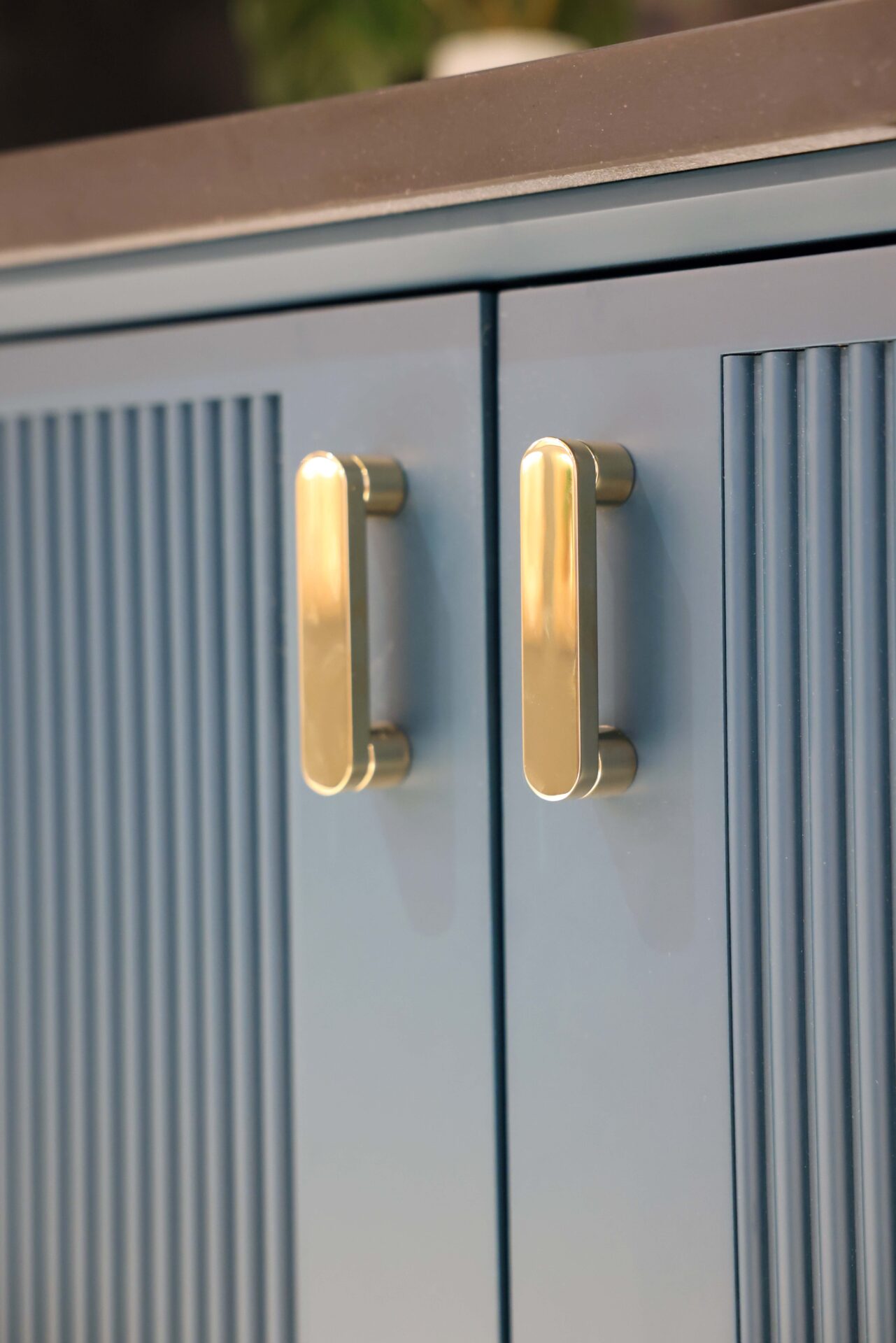 Textured teal vanity with gold handles
