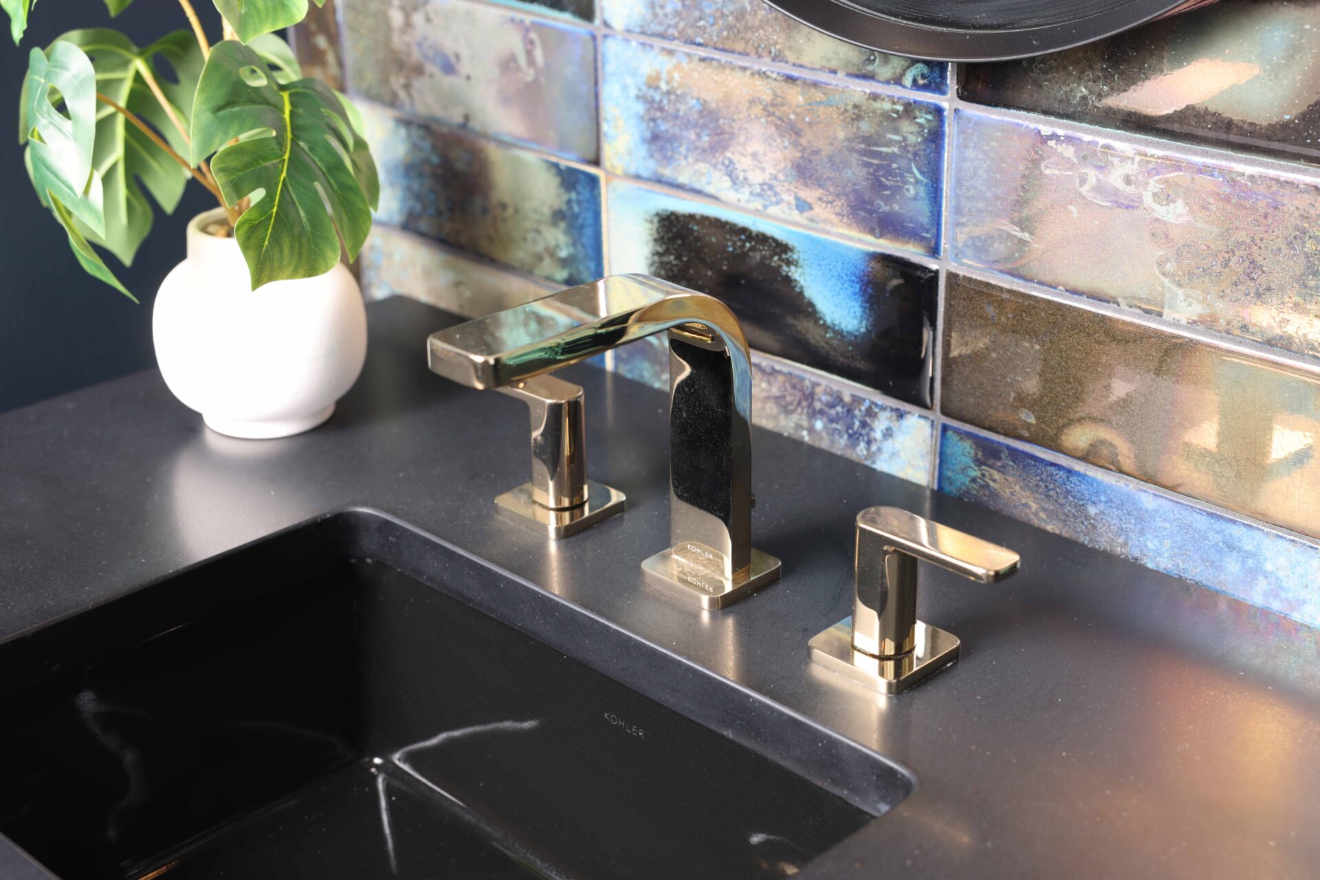 Iridescent tile backsplash in black powder room