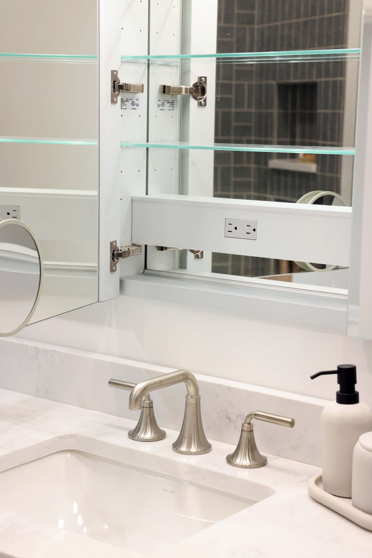 Hall bathroom recessed medicine cabinet with outlet and mirror inside, quartz countertops, brushed nickel faucet