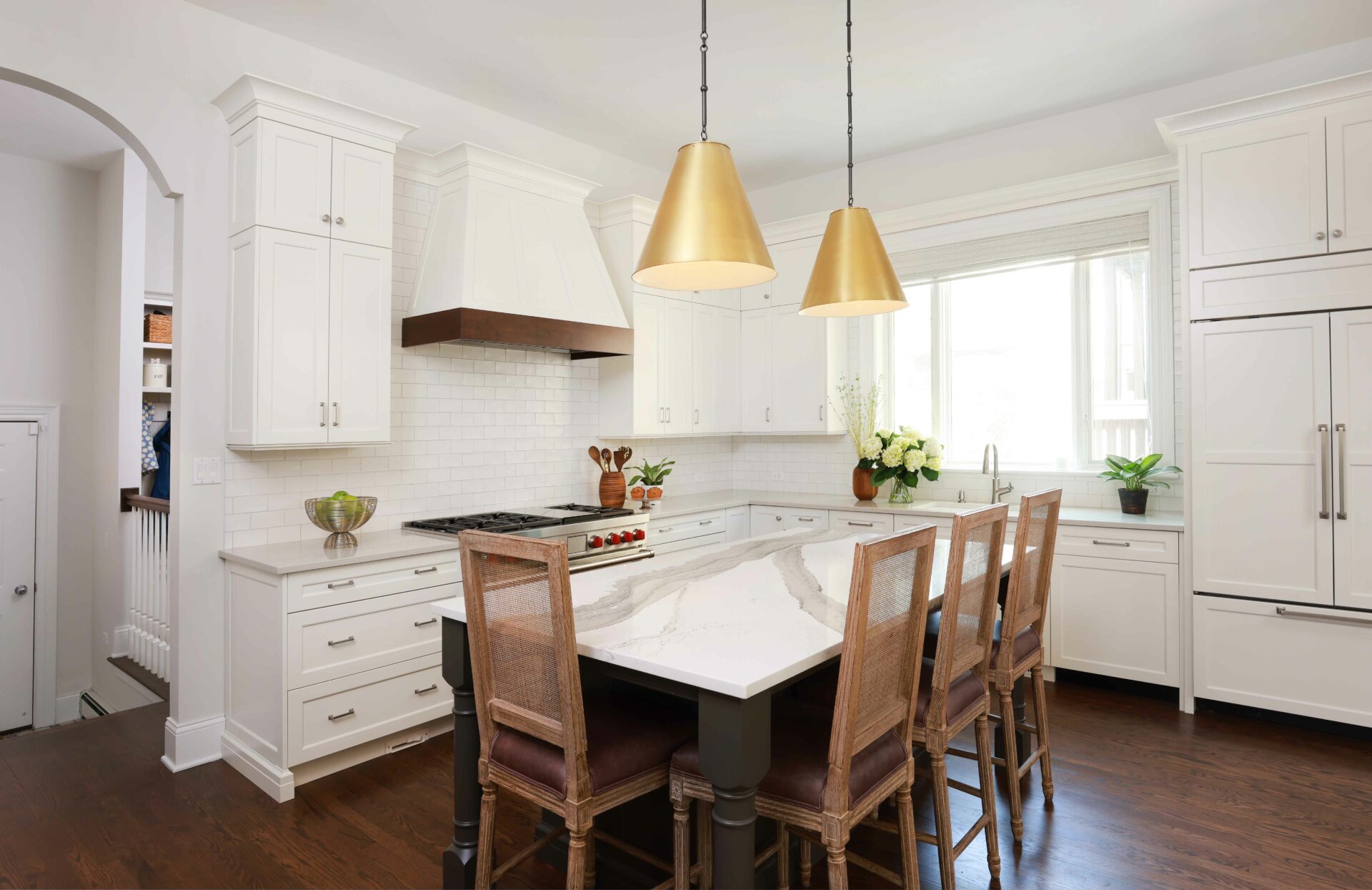 White kitchen cabinets with dark island
