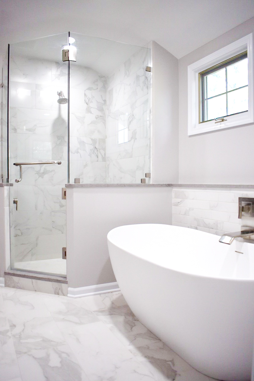 white bathroom with separate shower and tub