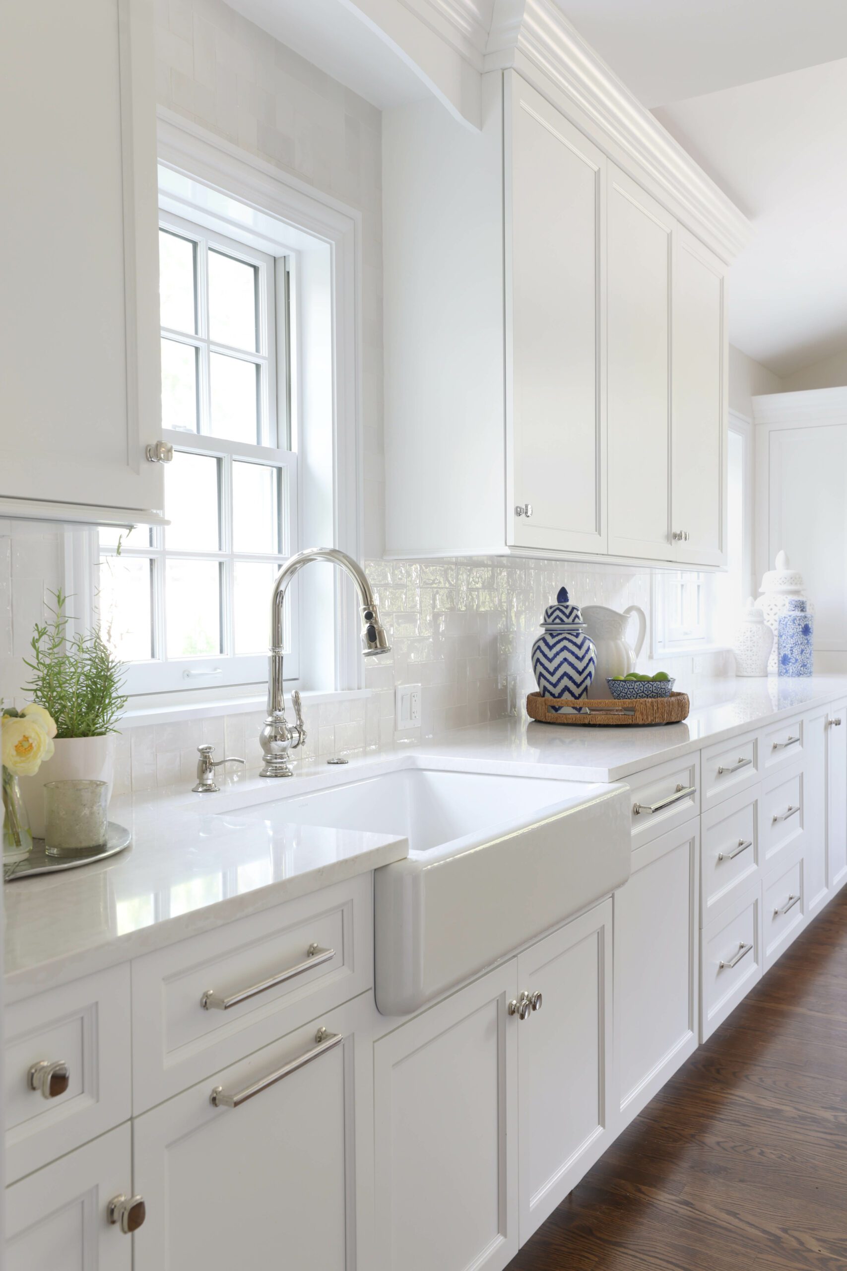 white kitchen with apron front sink and textured back splash