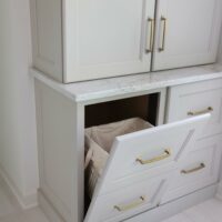 hidden tilt out hamper that looks like drawers