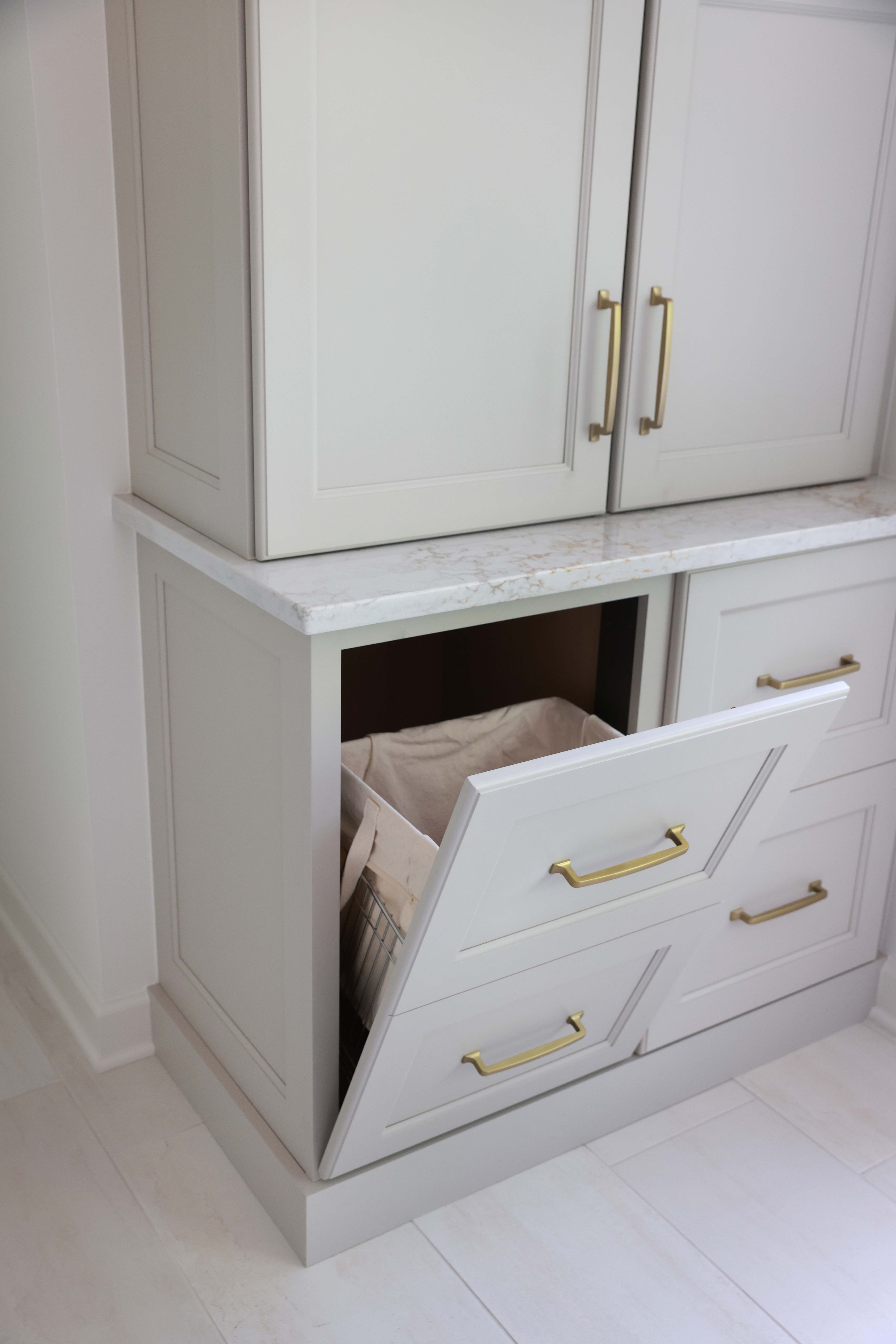 hidden tilt out hamper that looks like drawers