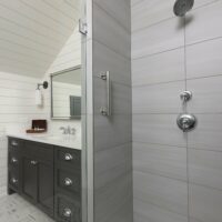 Farmhouse style bathroom with roll in shower and grab bars