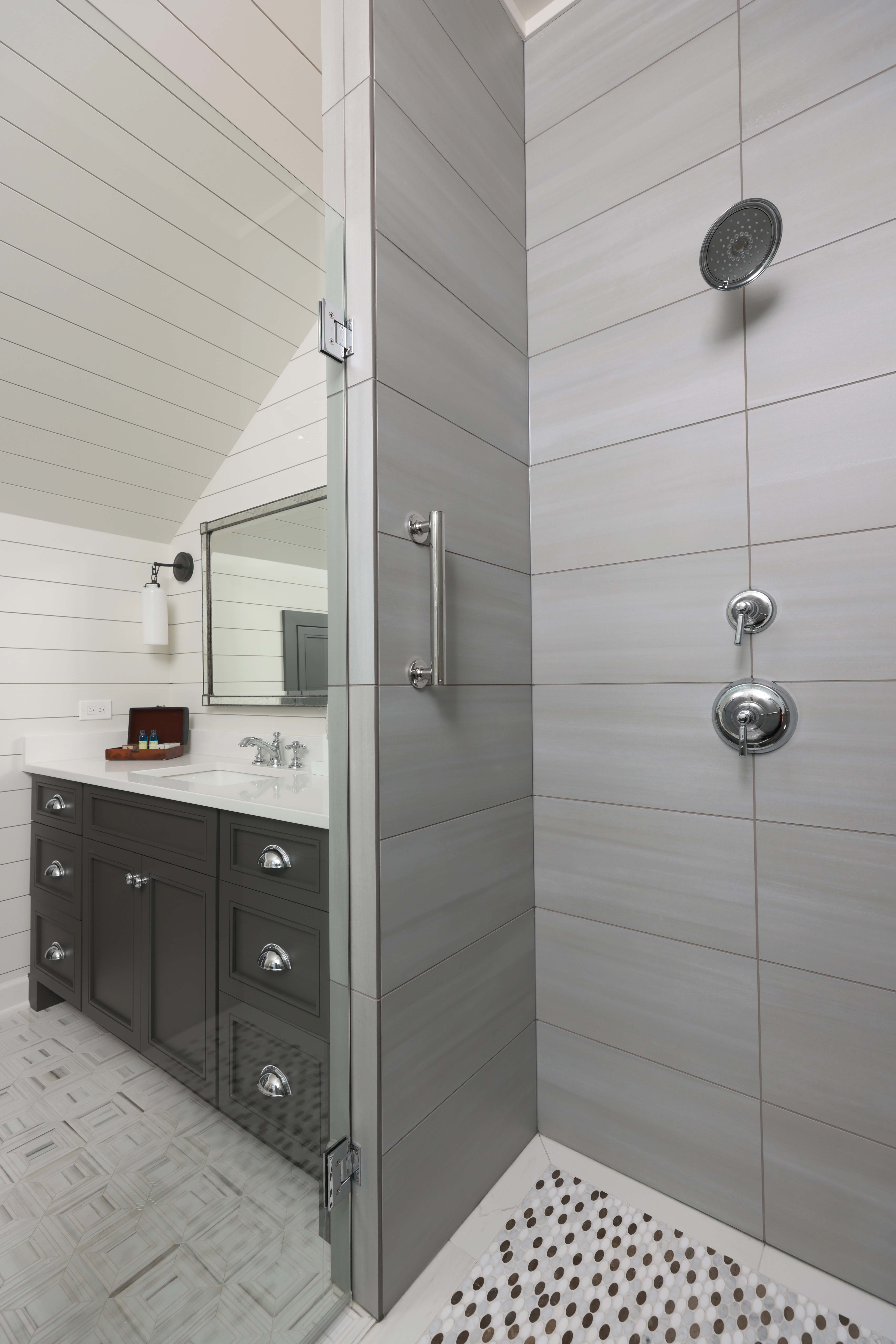 Farmhouse style bathroom with roll in shower and grab bars