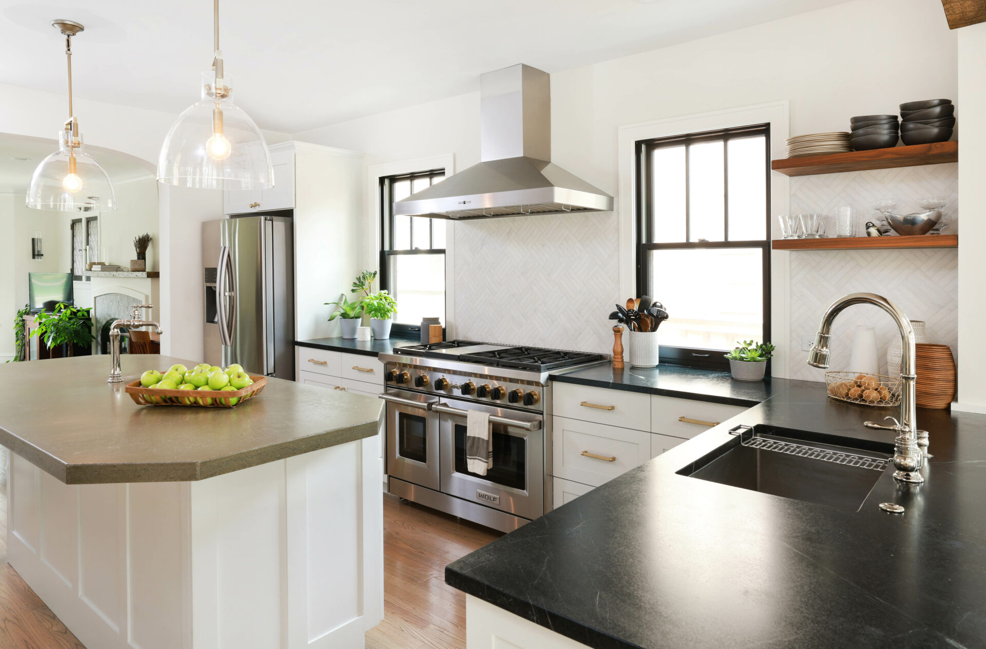 L shaped white kitchen with peninsula and island