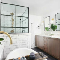 Primary bathroom with black accents and stained vanity