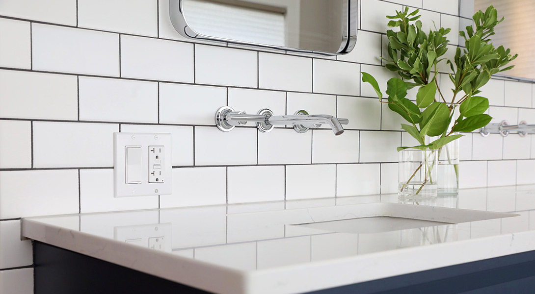 Wall mounted faucet and subway tile in master bathroom