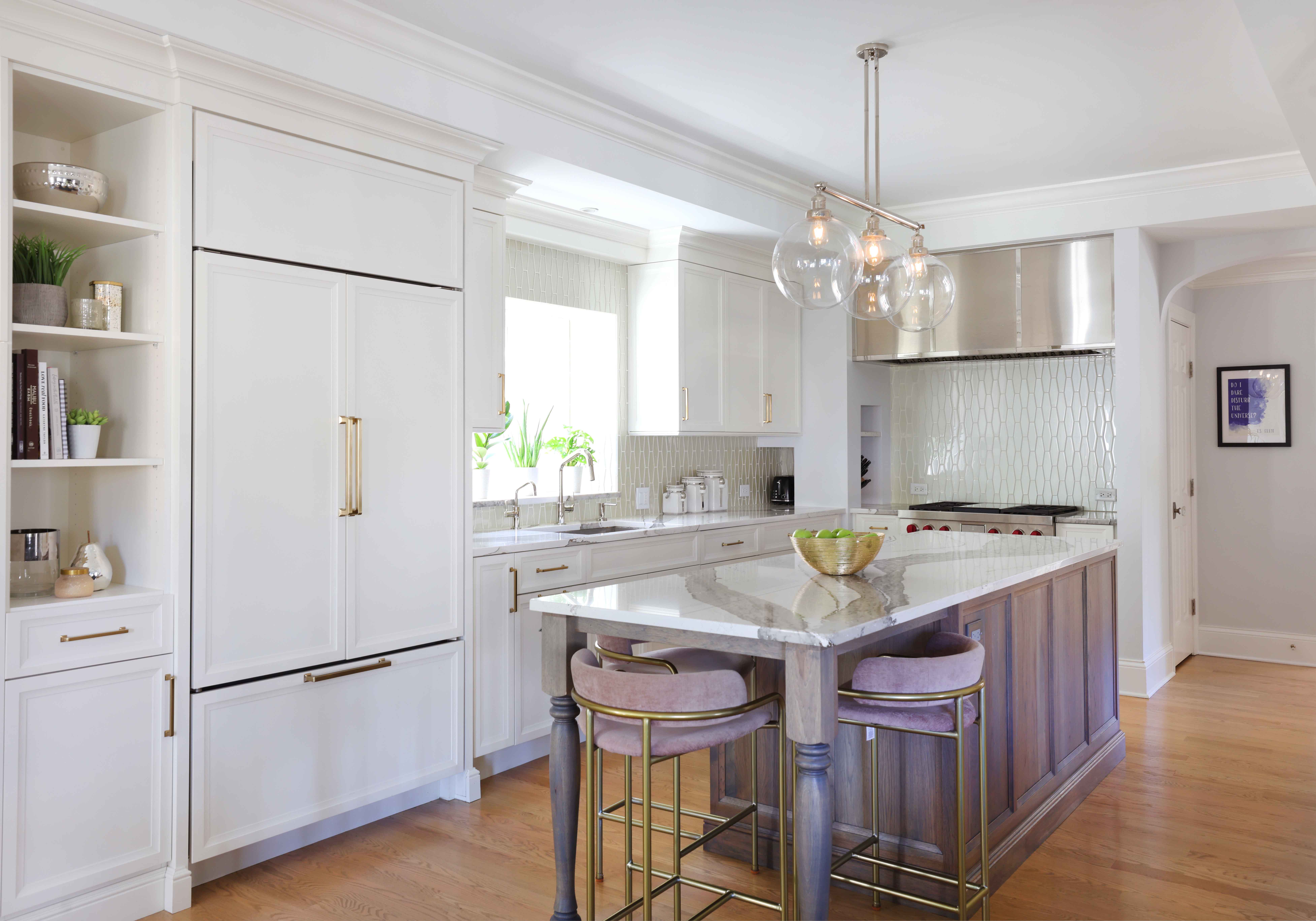 hickory island and stainless steel hood range, paneled fridge, quartz countertop and window above the sink