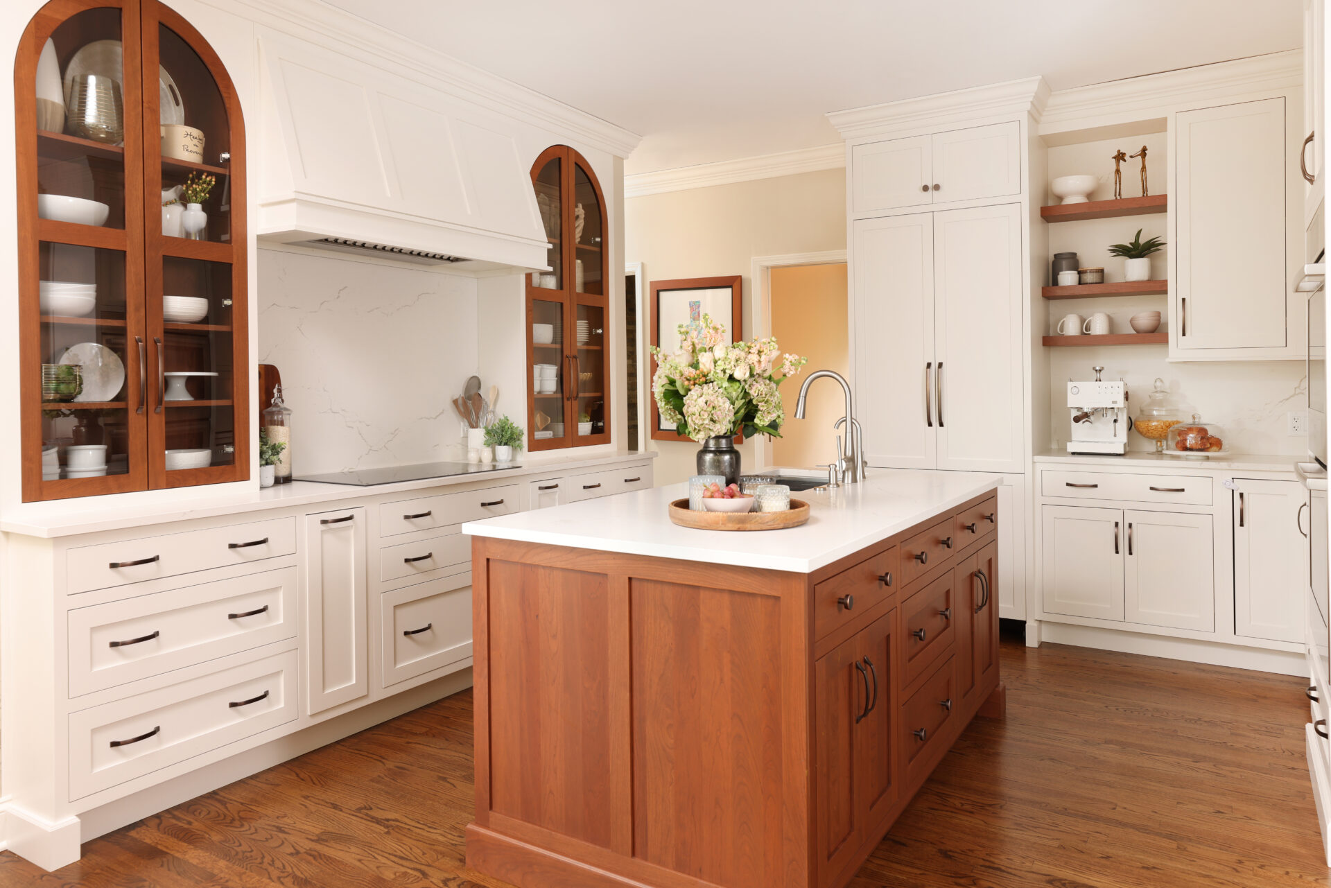 white kitchen arched cherry cabinetry and island