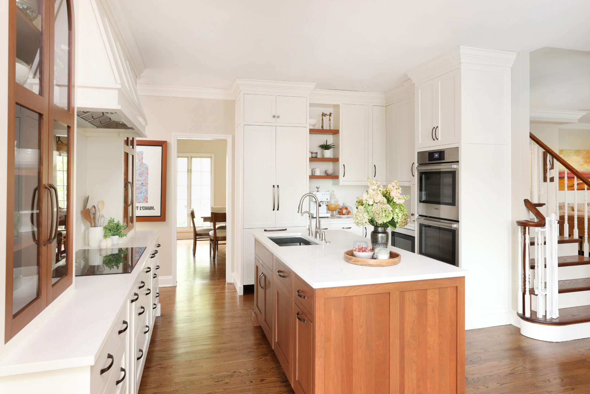 White kitchen with cherry arched cabinets and island