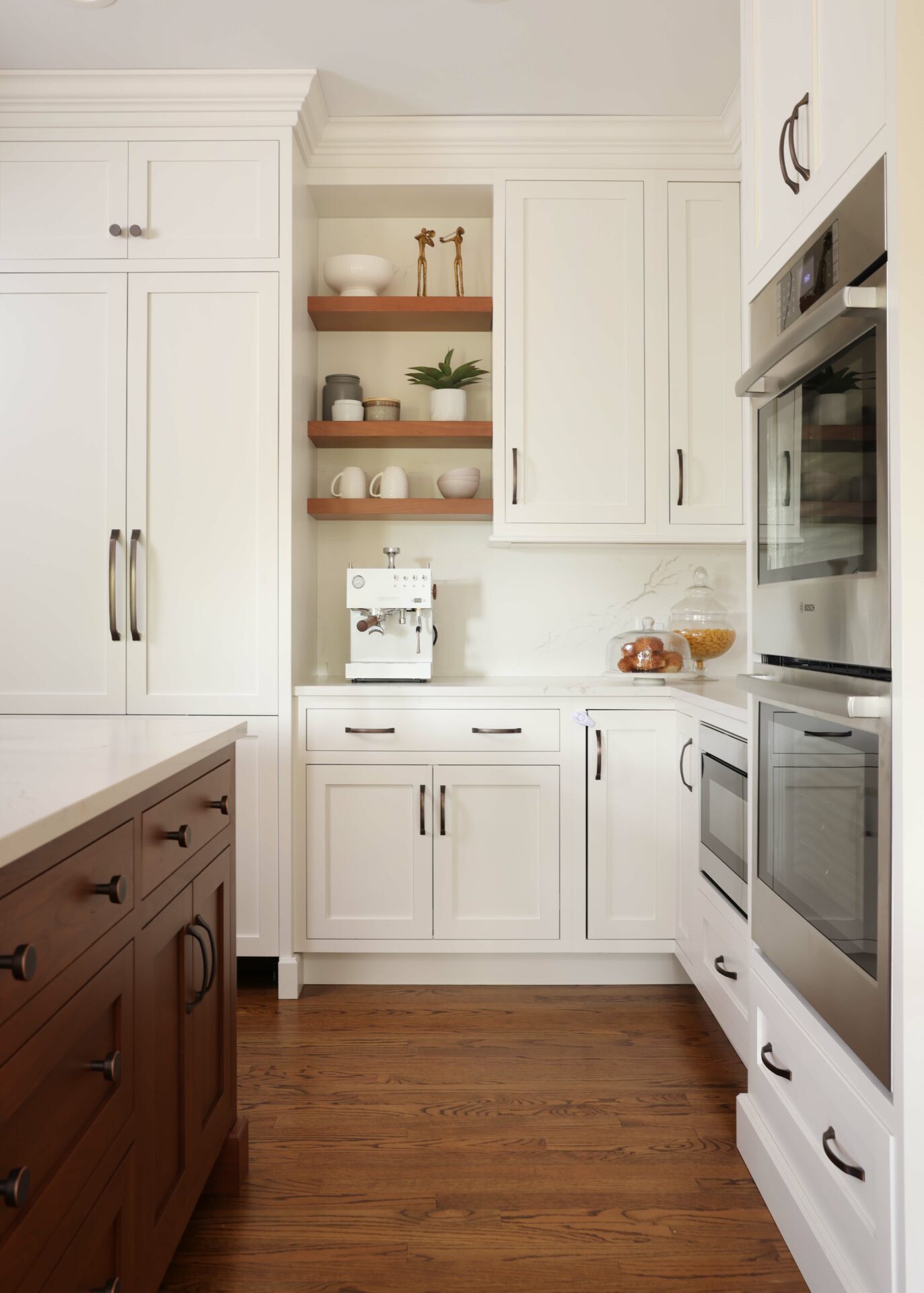 Winter white cabinetry with contrasting cherry shelving and island