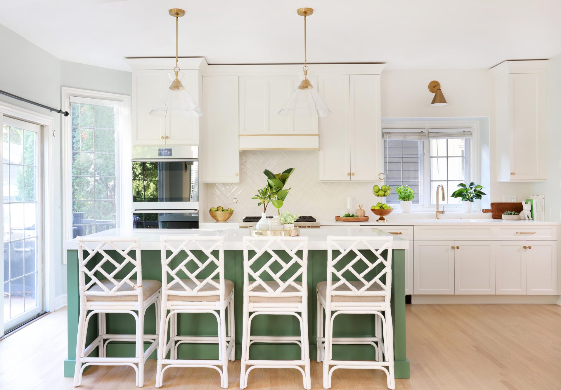 White kitchen with green island and gold accents