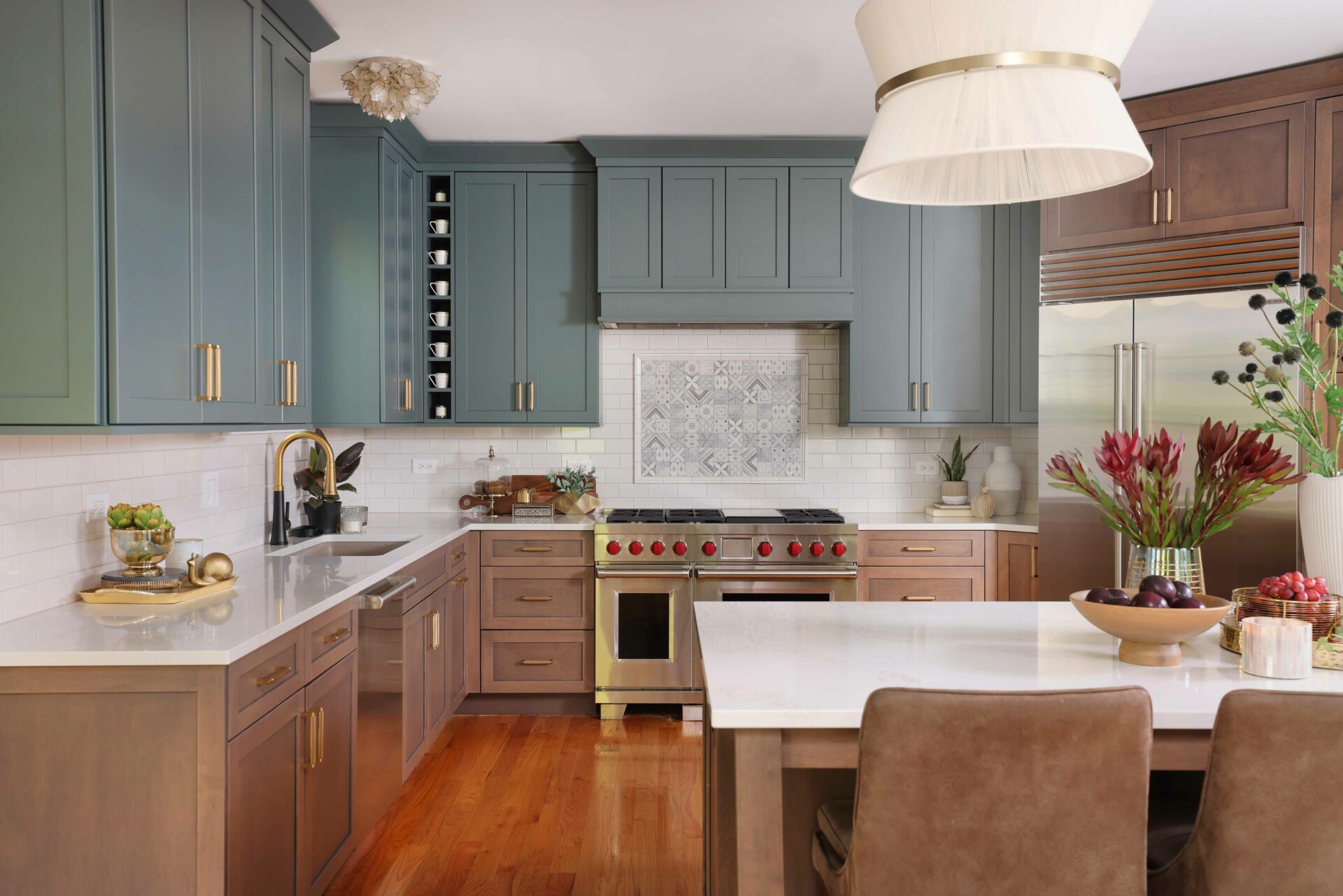 Blue green kitchen upper cabinets with medium tone maple stained lower cabinets
