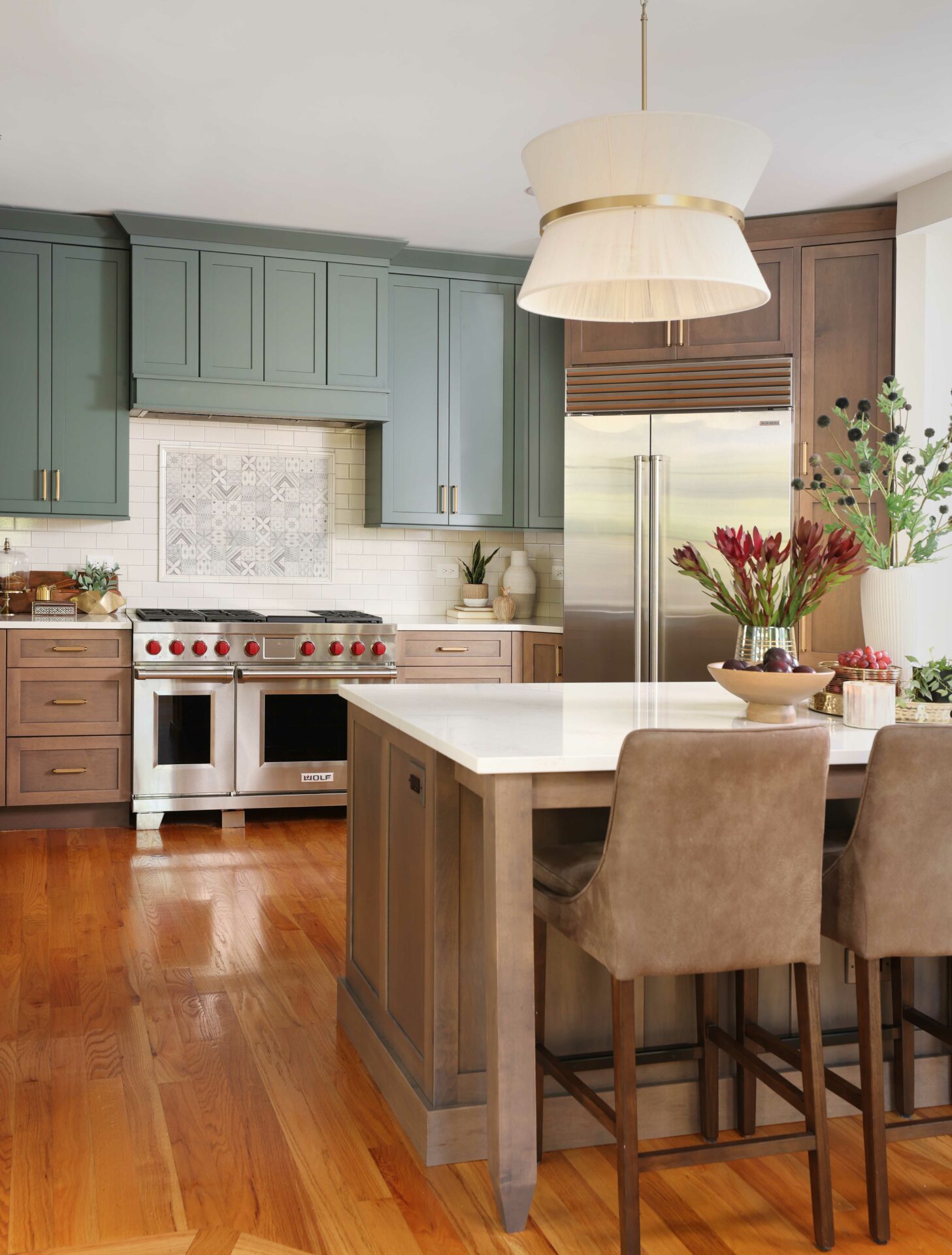 Soft blue green painted kitchen cabinets with stained medium tone maple cabinets