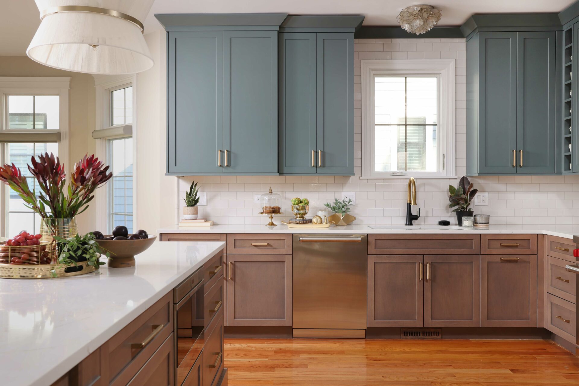 Kitchen with maple stained lower cabinets and blue-green painted upper cabinets