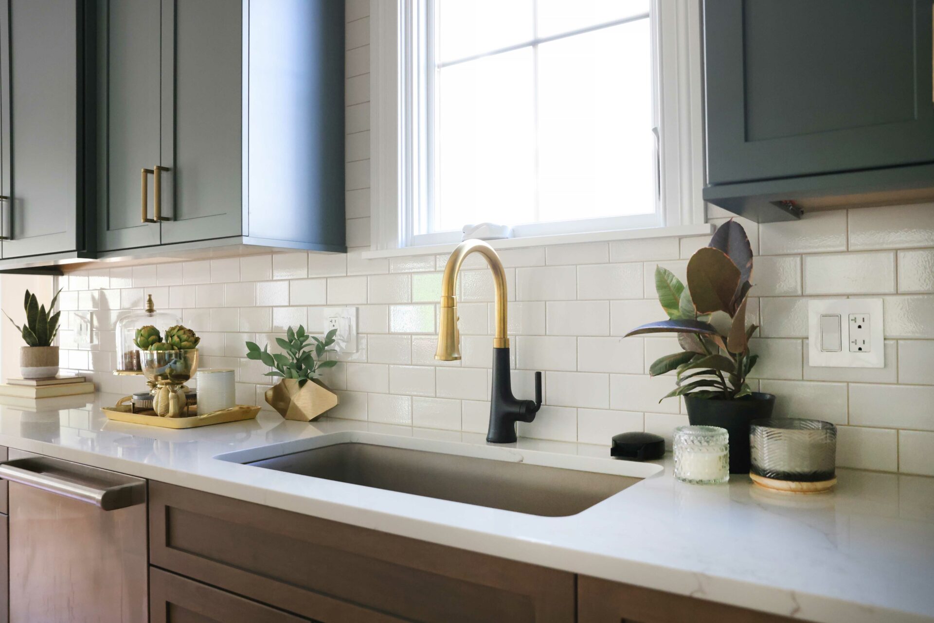 Taupe kitchen sink with matte black and gold faucet