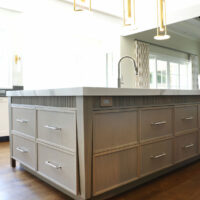 Rift cut white oak island in a light stain with decorative furniture legs