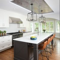 large island with stools, metal ceiling, mullion cabinets
