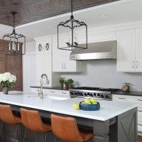 large island with stools, metal ceiling, mullion cabinets