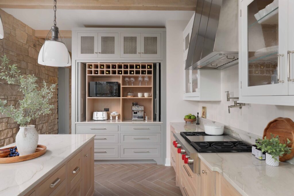 Modern farmhouse kitchen island features a baking center with a pull-out bread drawer, warming drawer and mixer lift.
