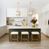 soft white kitchen with contrasting dark island has a modern appeal with classic touches
