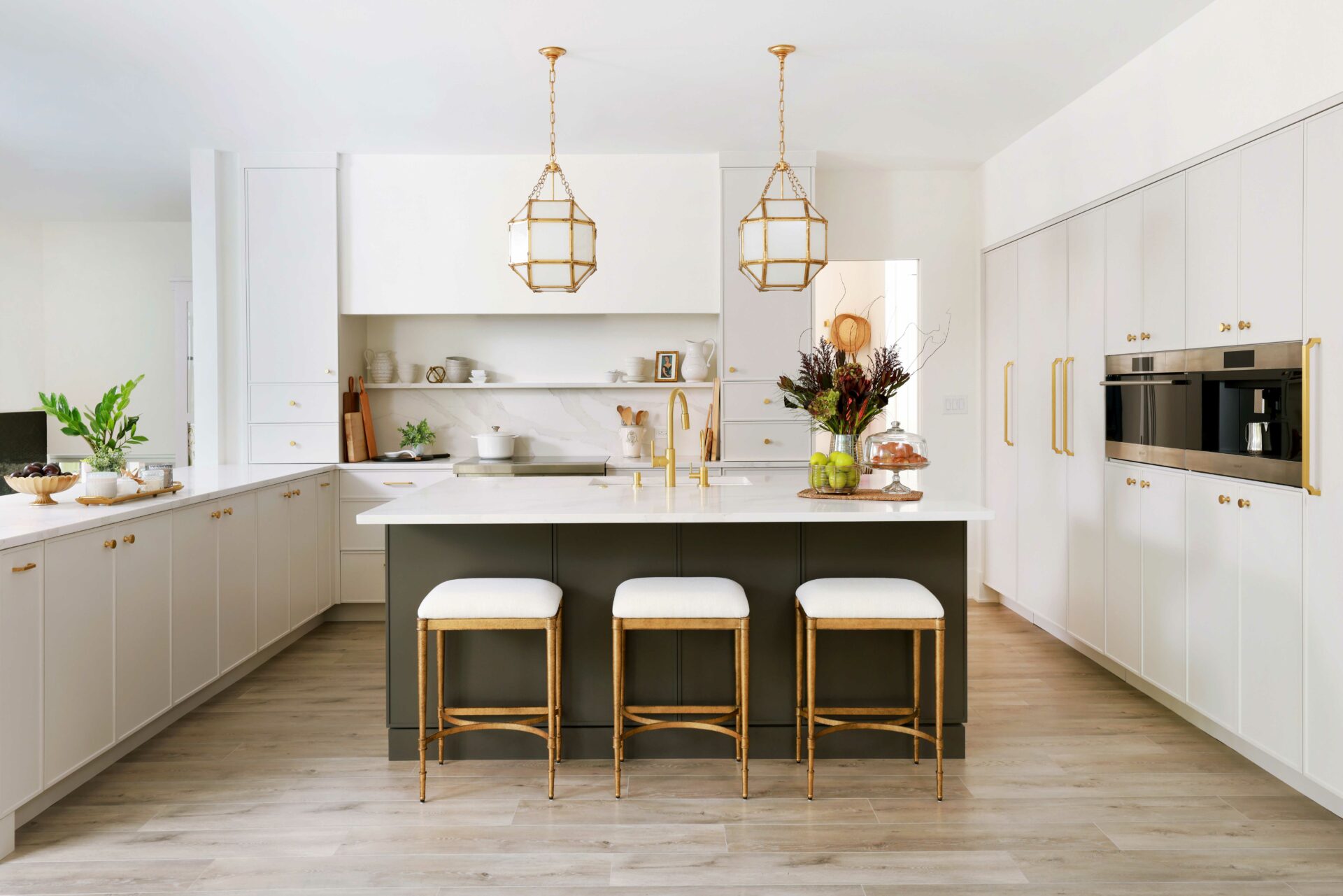 soft white kitchen with contrasting dark island has a modern appeal with classic touches