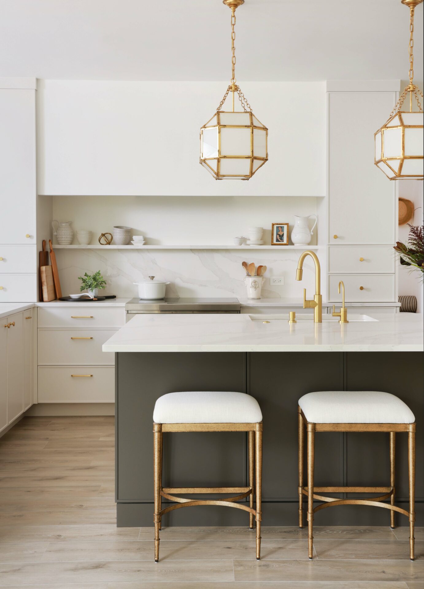 Modern white kitchen with dark gray island and drywall hood