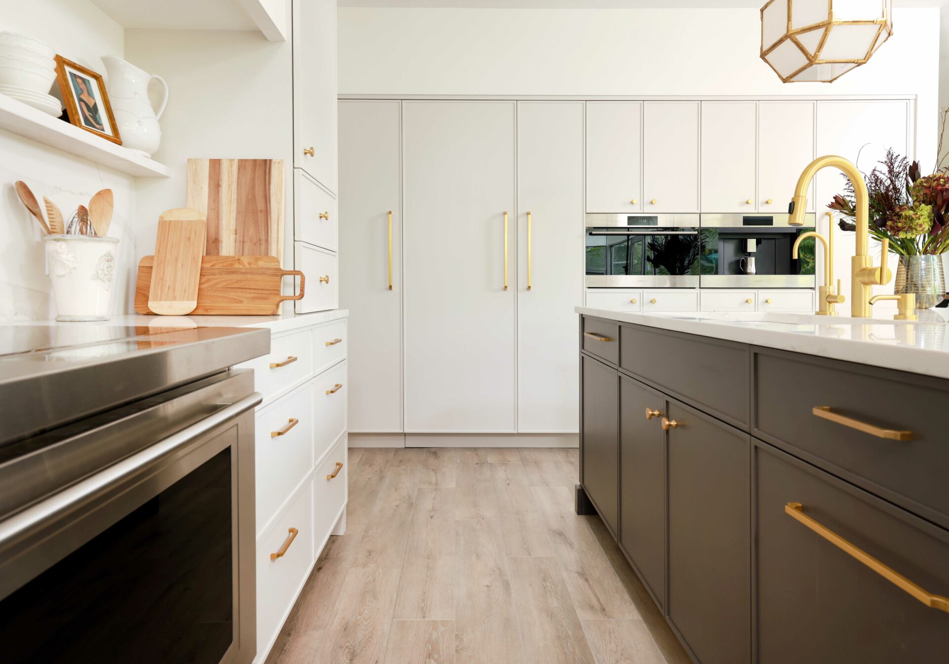 modern off-white kitchen with dark painted island is filled with classic details