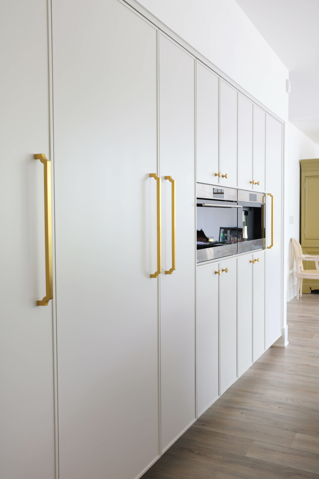 soft white kitchen cabinetry including paneled appliances