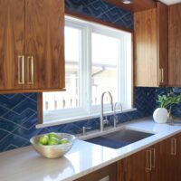 stained modern kitchen cabinets with blue backsplash