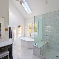 Primary bathroom with vaulted ceilings, freestanding bathtub, separate shower